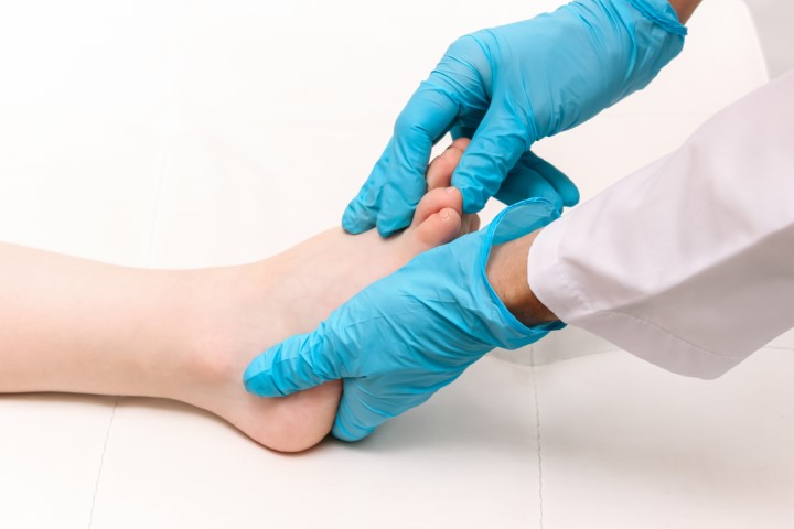 image of doctor examining foot